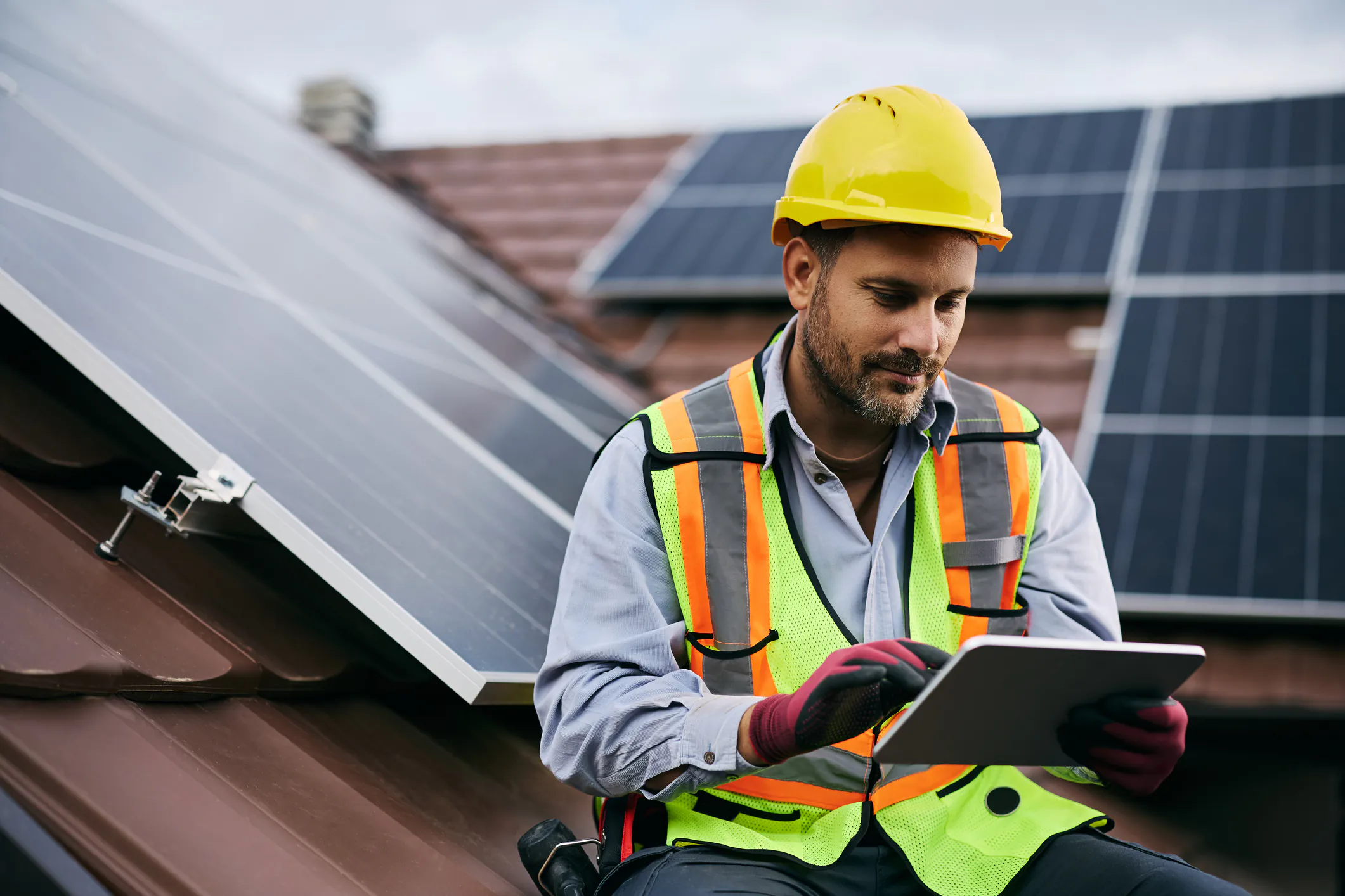 Solar field tech reviewing documentation with AI on a tablet